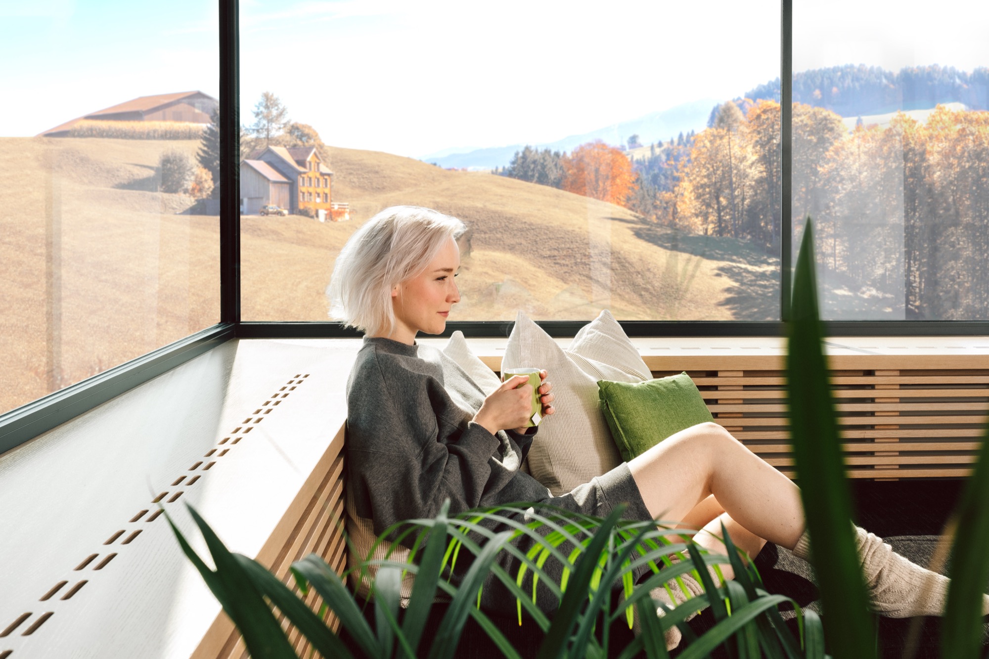 Warm window seat with corner glass overlooking autumn hills